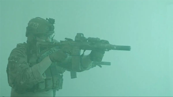 soldier in a green fog has gun raised