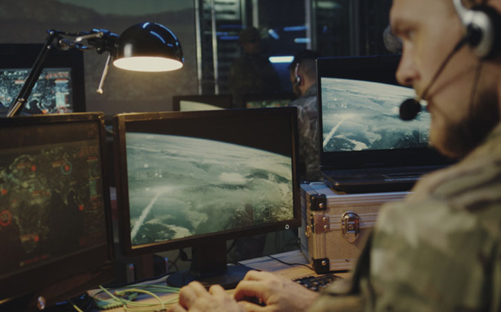 military personnel monitors computer screens