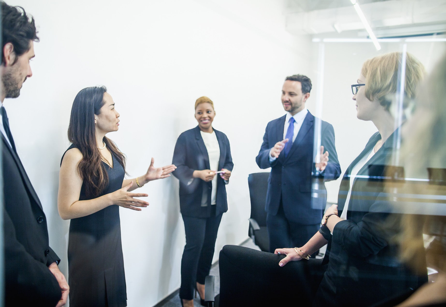 coworkers discuss while in a office meeting